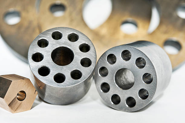 Metal flanges cylinders and brass nuts. CNC milling and lathe industry.